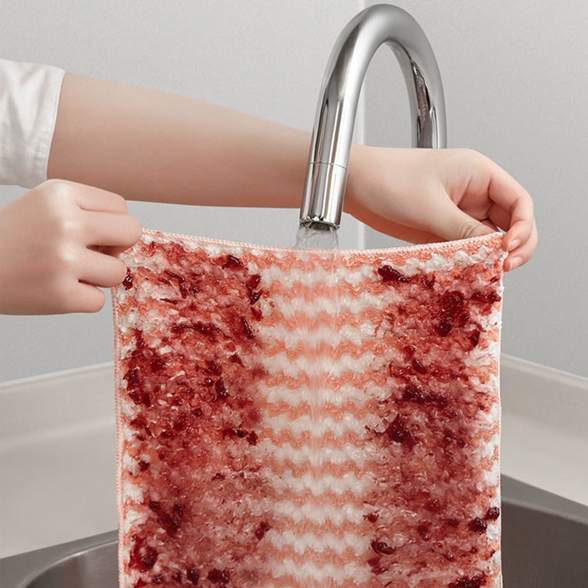 Reusable microfiber cloth being rinsed clean